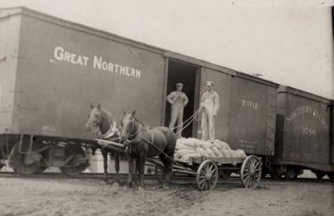 Men unloading railcar in Frost, Minnesota